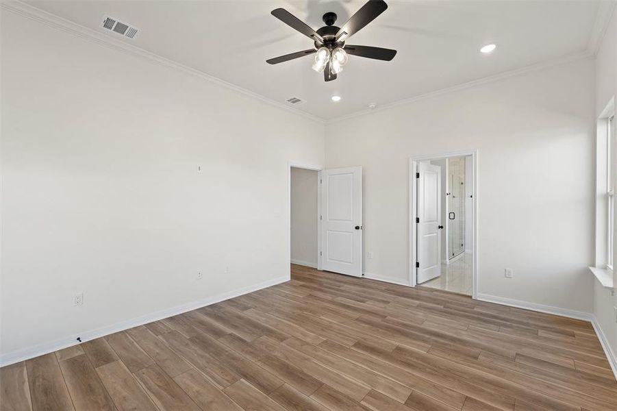 Unfurnished bedroom with crown molding, light wood-style flooring, a ceiling fan, and recessed lighting