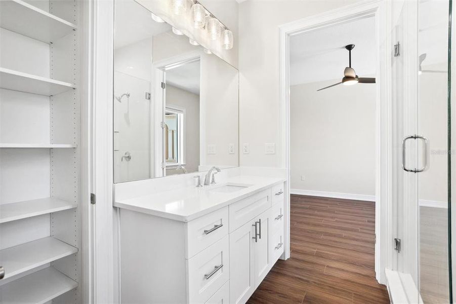 Jack and Jill Bath between Guest Bedrooms 2 and 3; custom linen closet finishes.