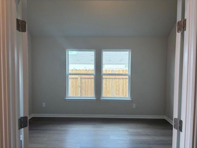 Unfurnished room with dark wood-style floors and baseboards Unfurnished room with dark wood-style floors and baseboards