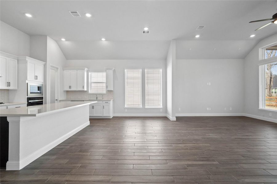 Create lasting memories around the table with family and friends in the dining! It showcases high ceilings, large windows, wood-look tile flooring, and recessed lighting for a warm and welcoming atmosphere. Create lasting memories around the table with family and friends in the dining! It showcases high ceilings, large windows, wood-look tile flooring, and recessed lighting for a warm and welcoming atmosphere.