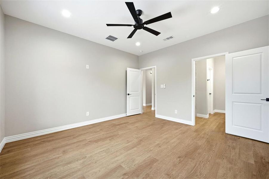 Unfurnished bedroom featuring light wood-style floors, ceiling fan, and recessed lighting Unfurnished bedroom featuring light wood-style floors, ceiling fan, and recessed lighting