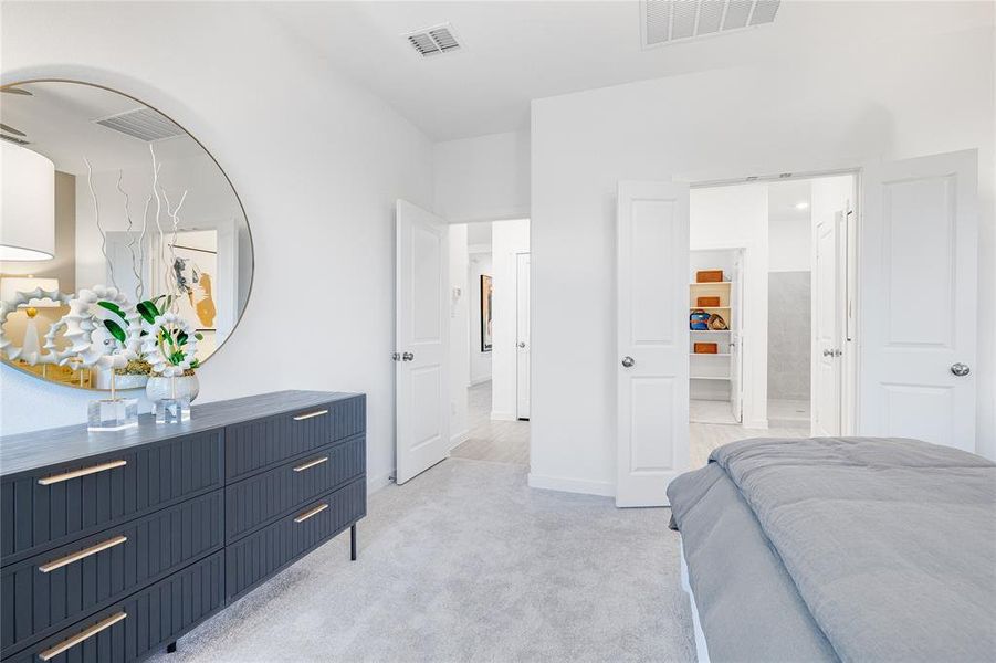 Bedroom featuring light carpet