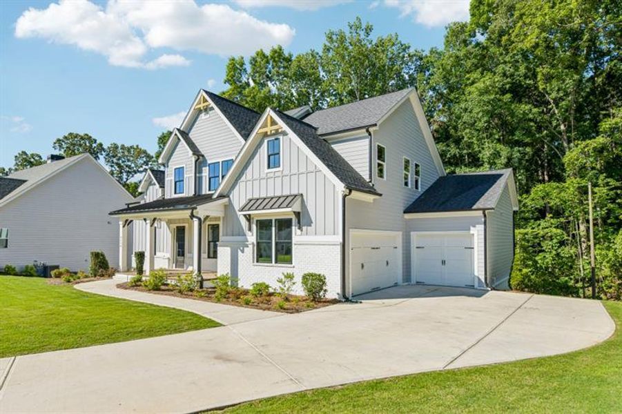 Front exterior of a new home in White Post on Lake Lanier, Gainesville, GA, highlighting curb appeal (Image 2). Front exterior of a new home in White Post on Lake Lanier, Gainesville, GA, highlighting curb appeal (Image 2).