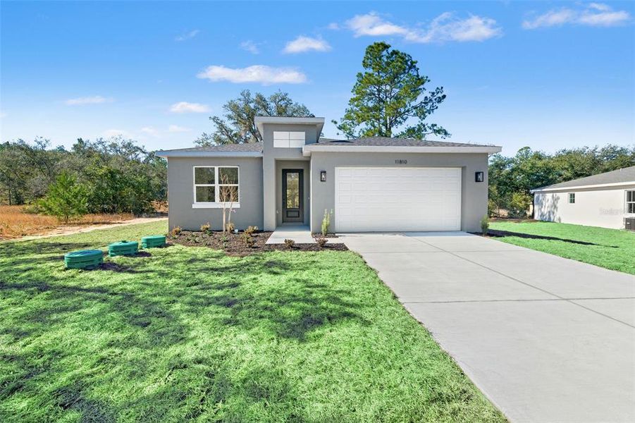 Front exterior of a new home in , Citrus Springs, FL, highlighting curb appeal (Image 27).