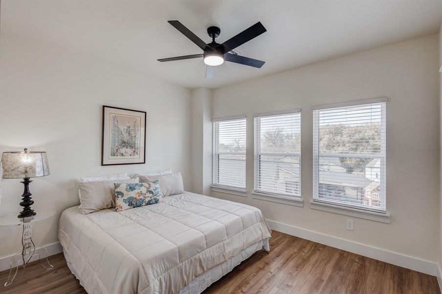 Bedroom with wood finished floors and ceiling fan Bedroom with wood finished floors and ceiling fan