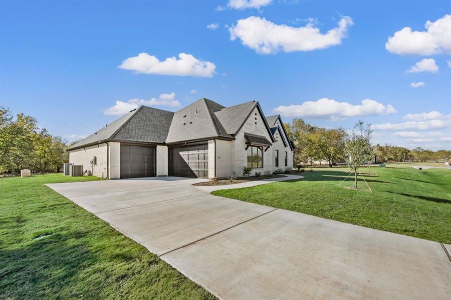 Front exterior of a new home in Rolling Creek Ranch, Aledo, TX, highlighting curb appeal (Image 2). Front exterior of a new home in Rolling Creek Ranch, Aledo, TX, highlighting curb appeal (Image 2).