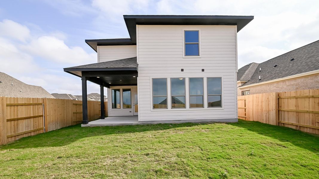 Rear view of house featuring a patio, a fenced backyard, and a shingled roof Rear view of house featuring a patio, a fenced backyard, and a shingled roof