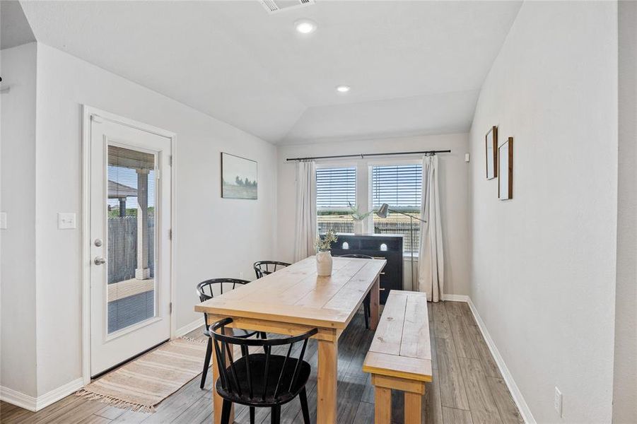 Dining space featuring lofted ceiling, light wood-style floors, plenty of natural light, and recessed lighting