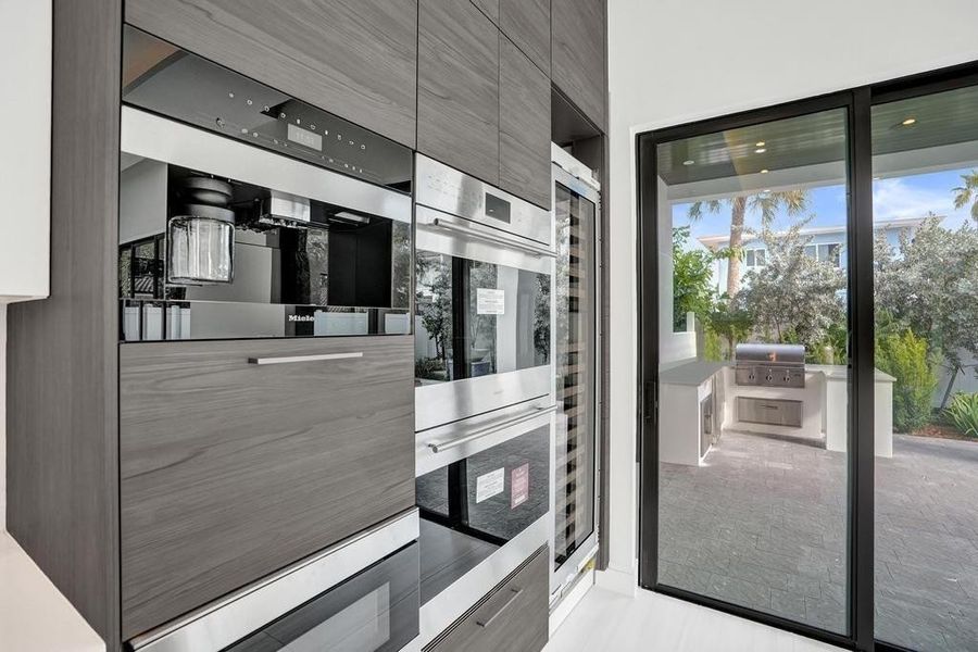 Chef’s Kitchen.. Gas Cooktop, Double Ovens, and Espresso Maker, Oversized Wine / Beverage Cooler.