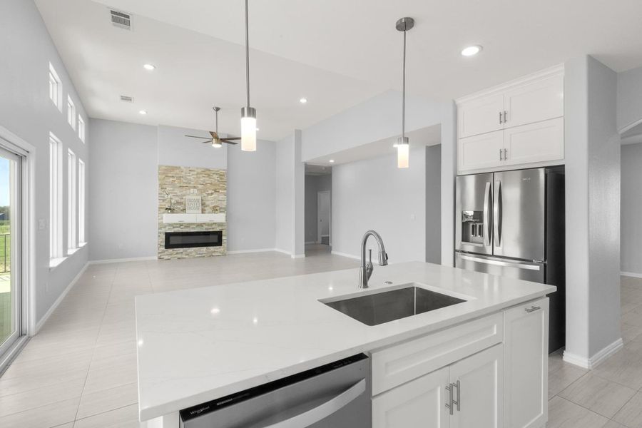 Kitchen with stainless steel appliances, ceiling fan, decorative light fixtures, white cabinetry, and recessed lighting Kitchen with stainless steel appliances, ceiling fan, decorative light fixtures, white cabinetry, and recessed lighting