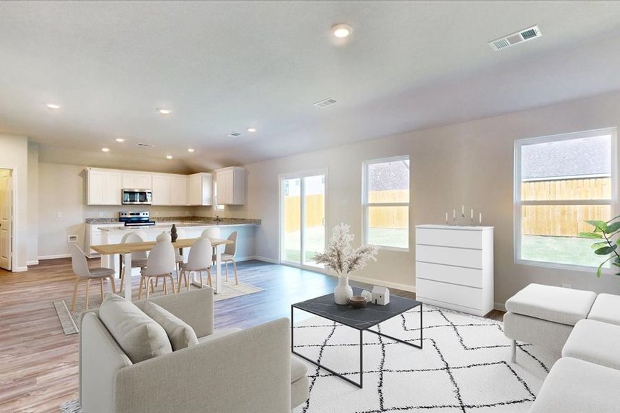 A large living room with a dining table and couches. A large living room with a dining table and couches.