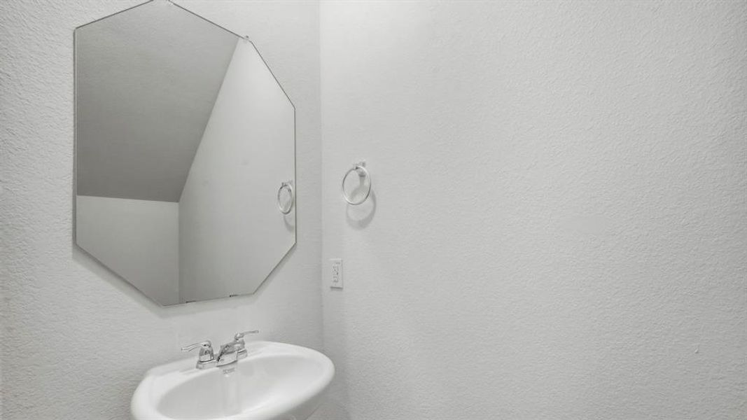 Bathroom with a textured wall and a sink