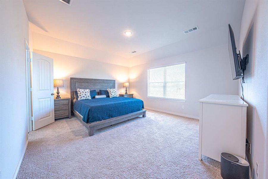 Bedroom featuring light carpet and recessed lighting
