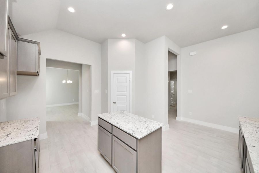 The extended counter area adds both practicality and style, making meal preparation a breeze. Every detail is thoughtfully designed to enhance the kitchen's functionality and aesthetic appeal. Sample photo of completed home with similar floor plan. Actual colors and selections may vary.