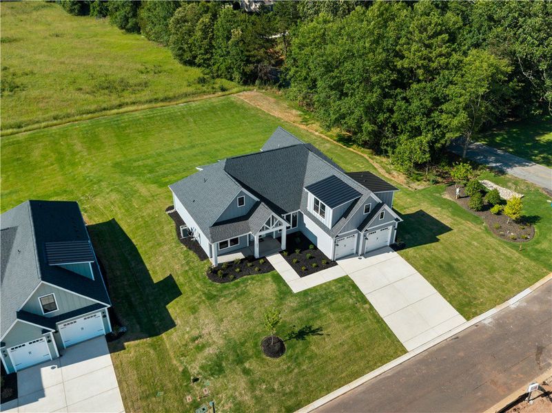 A newly built residence with a spacious lawn and i