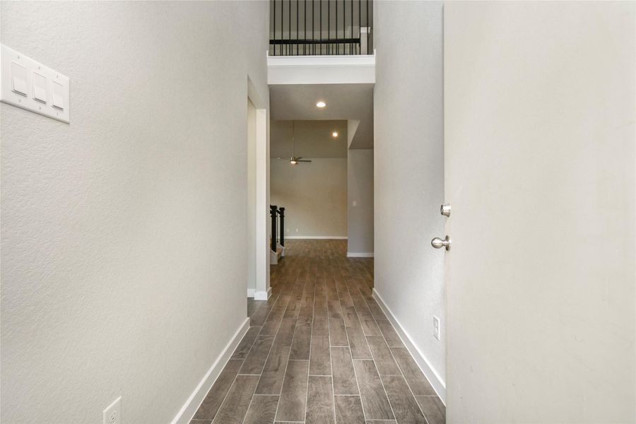 As you step into the threshold of this luxurious home, you'll soon be welcomed by anelegant glass door (to be installed). Inside, soaring ceilings amplify the spaciousness,while the refined wood-look tile flooring and oversized baseboards exudesophistication and charm. Sample photo of completed home with similar floor plan. Actual colors and selections may vary.
