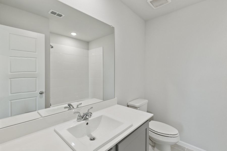 Bathroom in the Holden home plan by Trophy Signature Homes – REPRESENTATIVE PHOTO