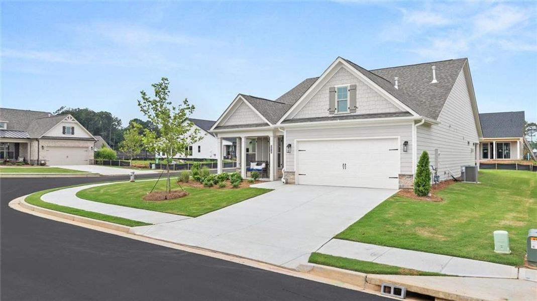 Front exterior of a new home in Soleil Summit Chase, Snellville, GA, highlighting curb appeal (Image 27). Front exterior of a new home in Soleil Summit Chase, Snellville, GA, highlighting curb appeal (Image 27).