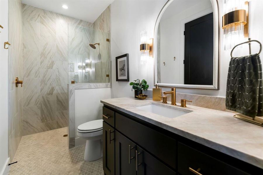 Bathroom with a walk in shower, vanity, and light tile patterned flooring Bathroom with a walk in shower, vanity, and light tile patterned flooring