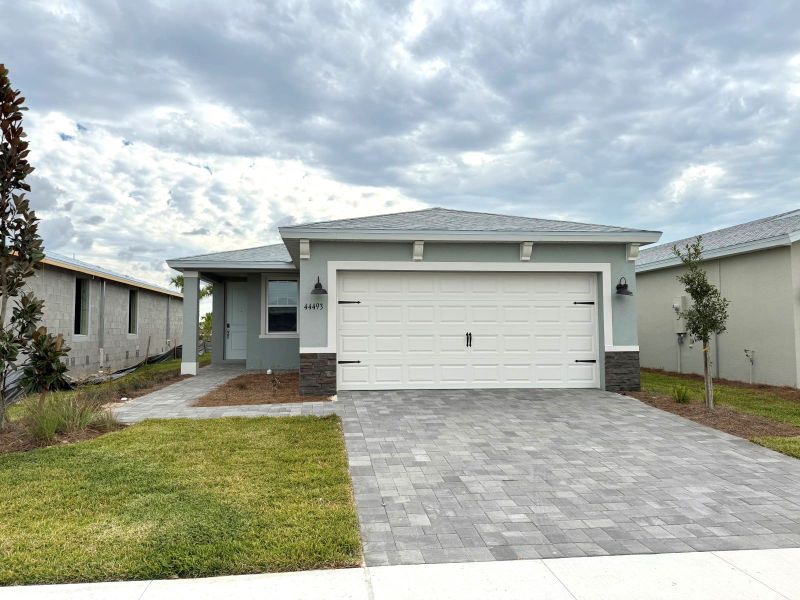 Front exterior of a new home in Crescent Lakes - Premier Series, Punta Gorda, FL, highlighting curb appeal (Image 8).