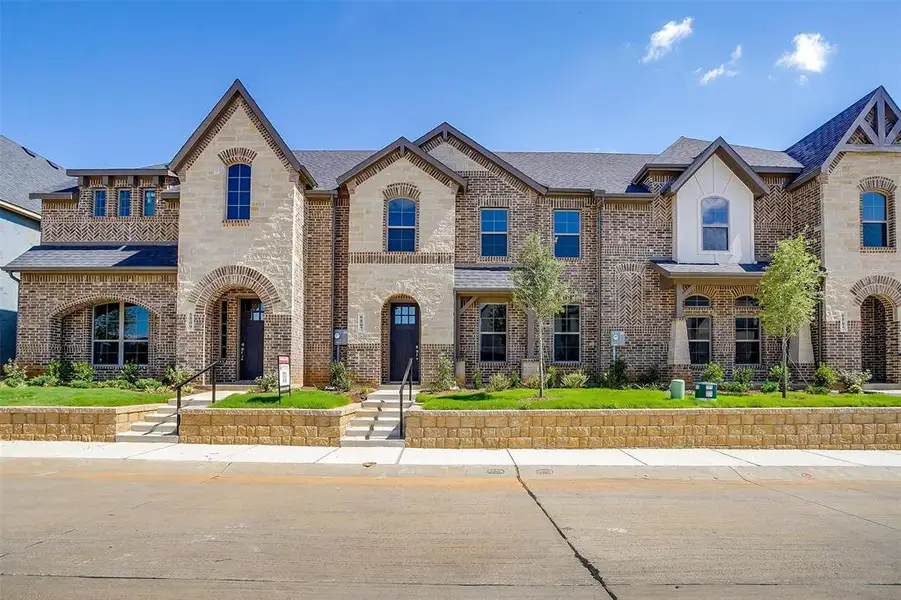 French provincial home with brick siding and roof with shingles