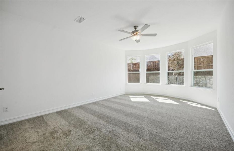 Elegant owner's suite with bay window *real home pictured