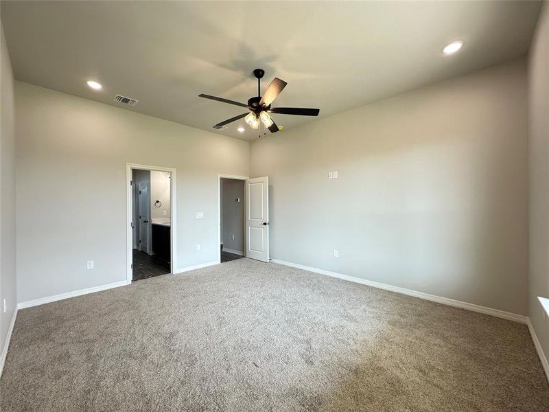 Unfurnished bedroom with recessed lighting, ensuite bath, carpet flooring, and a ceiling fan Unfurnished bedroom with recessed lighting, ensuite bath, carpet flooring, and a ceiling fan