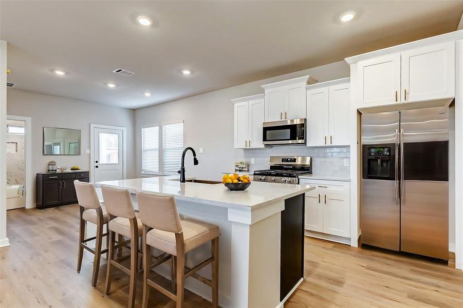 A chef’s dream! The gourmet kitchen features a farmhouse sink, stainless steel appliances, and custom cabinetry, making meal prep both functional and beautiful.