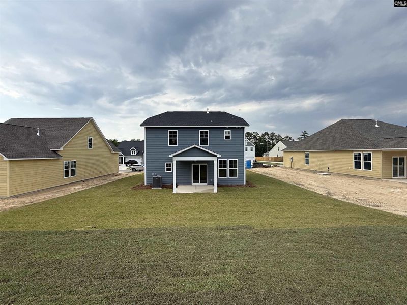 Exterior details and patio area of a home in Cottages at Roofs Pond, West Columbia (Image 4).