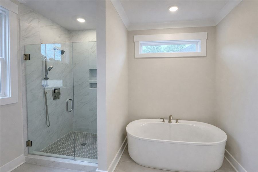 This primary bathroom features a spacious shower a