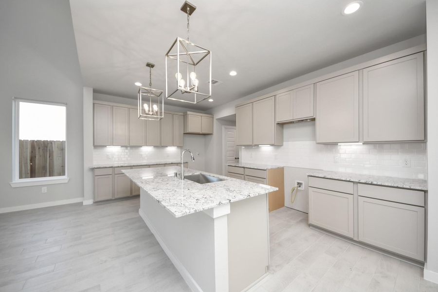This generously spacious kitchen is a dream realized! Sample photo of completed home with similar floor plan. Actual colors and selections may vary.