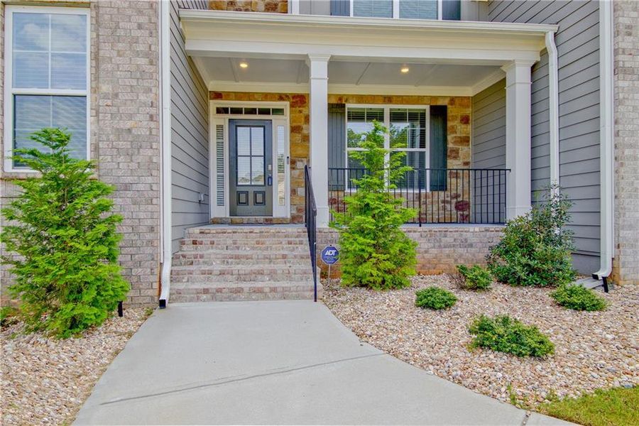 Front exterior of a new home in Genesee, Newnan, GA, highlighting curb appeal (Image 1).