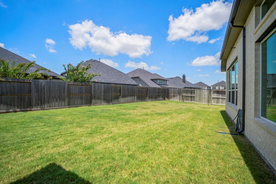 Bring the swing set, trampoline and all the yard toys. This expansive fenced backyard has plenty of room to run, play and enjoy time outdoors, while a full sprinkler system takes care of some of the grown-up stuff and helps keep the lawn looking its best.