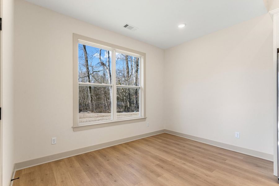Spare room with light wood-type flooring and recessed lighting