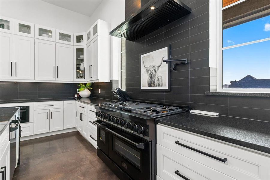 The ZLINE gas range and double oven surrounded by soft close drawers and cabinets. Everything hand selected and custom in this home.