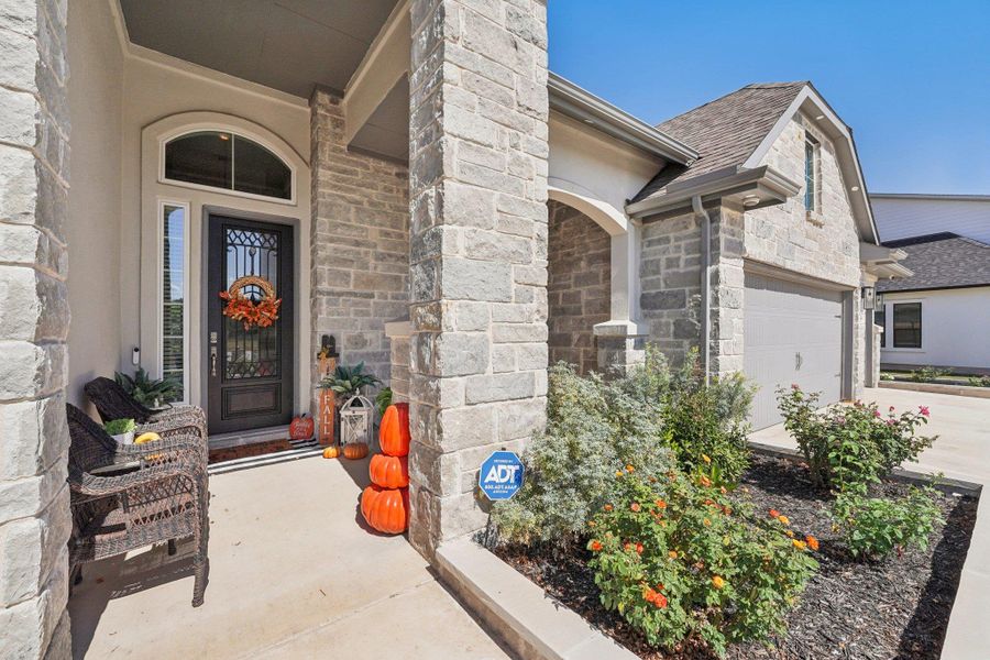 A welcoming covered front porch sets the tone for the home’s warm and inviting style.