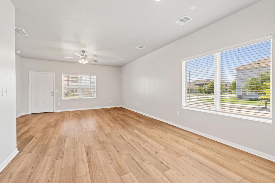 Unfurnished room featuring light wood-style floors and a ceiling fan Unfurnished room featuring light wood-style floors and a ceiling fan