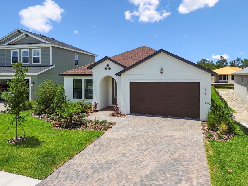 Front exterior of a new home in Avalon West, Spring Hill, FL, highlighting curb appeal (Image 11).