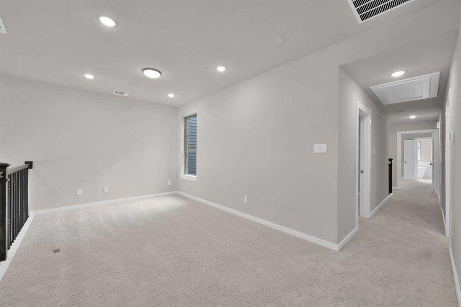 Flexible upstairs retreat perfect for media, play, or work-from-home. (Original builder photo w/out staging)