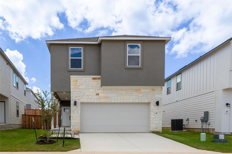 Front exterior of a new home in Ryegrass Collection – Freedom at Anthem, Kyle, TX, highlighting curb appeal (Image 1).