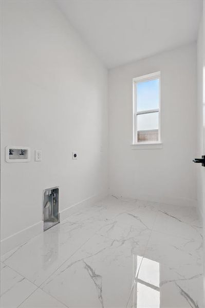 Laundry area featuring electric dryer hookup, washer hookup, baseboards, and marble finish flooring