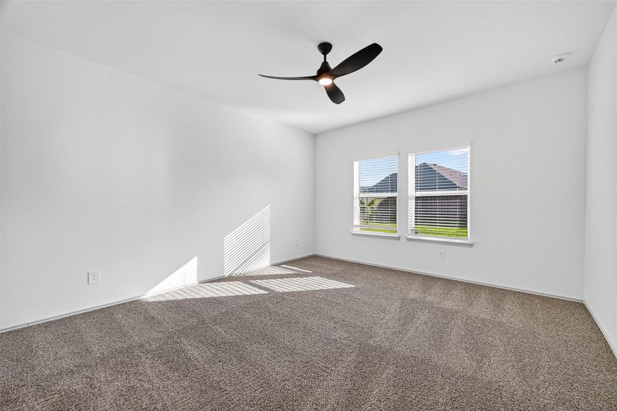 The large primary bedroom is located on the first floor for convenient living.