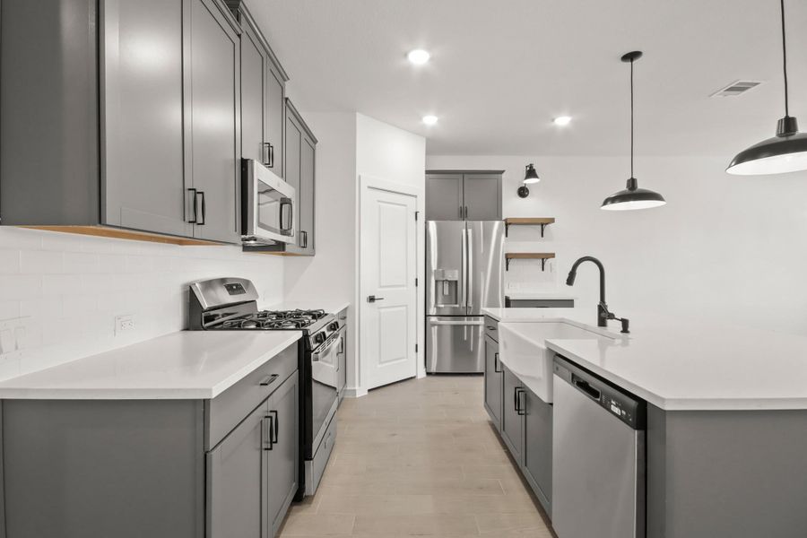 Stylish kitchen with grey cabinets and quartz counters Stylish kitchen with grey cabinets and quartz counters