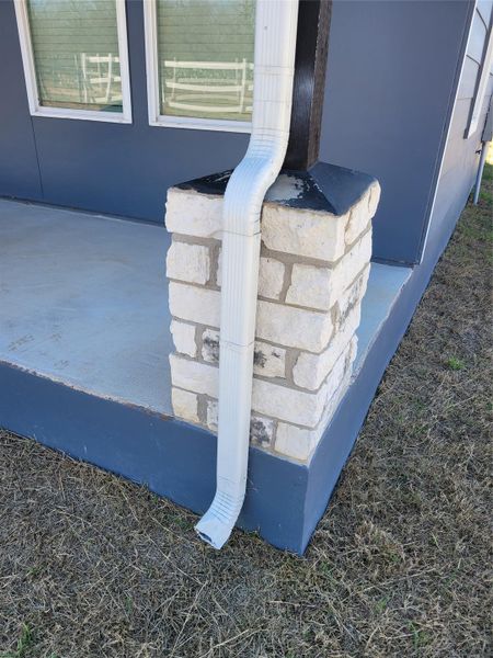A well-maintained home with a charming stone column and a clean, accessible porch. A well-maintained home with a charming stone column and a clean, accessible porch.