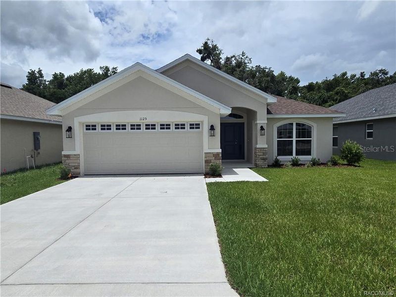 Front exterior of a new home in Wyld Palms, Inverness, FL, highlighting curb appeal (Image 12). Front exterior of a new home in Wyld Palms, Inverness, FL, highlighting curb appeal (Image 12).