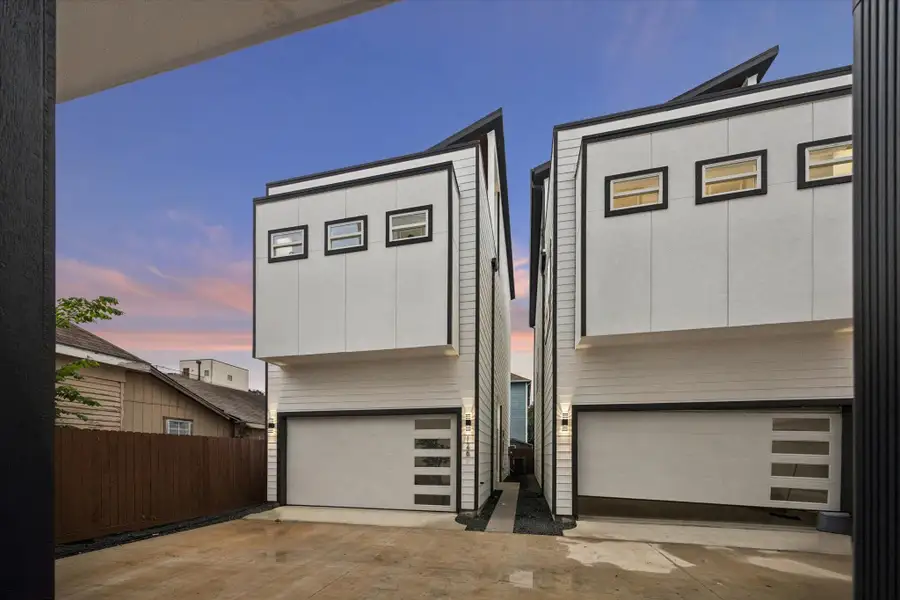 Modern twin townhouses with clean lines and contemporary design. Each features a two-car garage and large windows, set against a serene evening sky. Modern twin townhouses with clean lines and contemporary design. Each features a two-car garage and large windows, set against a serene evening sky.