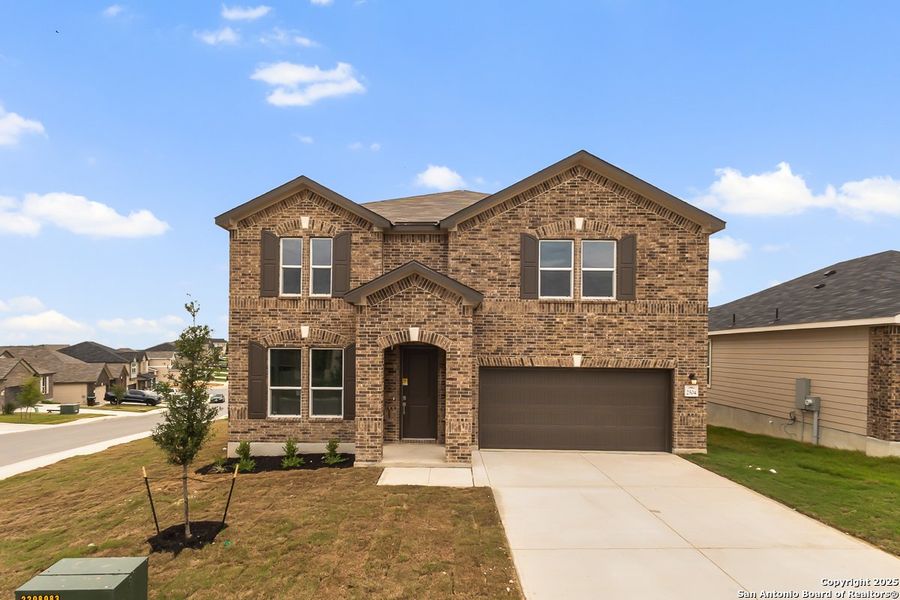 Front exterior of a new home in Hidden Bluffs at TRP, San Antonio, TX, highlighting curb appeal (Image 1).