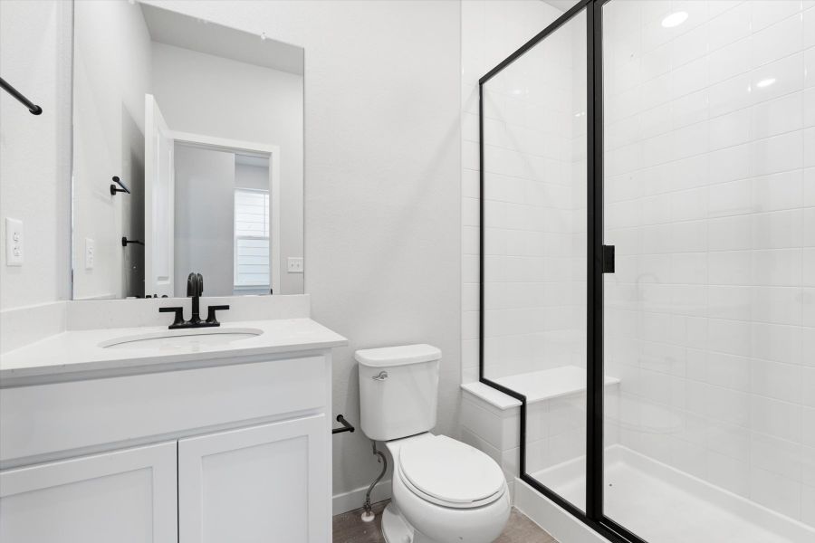 A bathroom with a glass shower. A bathroom with a glass shower.