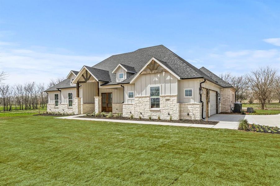 Craftsman-style house featuring board and batten siding, a shingled roof, concrete driveway, a garage, and a front yard Craftsman-style house featuring board and batten siding, a shingled roof, concrete driveway, a garage, and a front yard