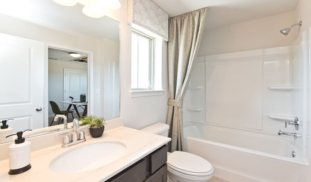 A jack-and-jill style bathroom connects the two secondary bedrooms.